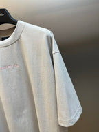 T-shirt sleeve detail in light gray with curved hem