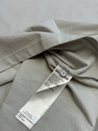 Light gray T-shirt folded with visible care and label tags