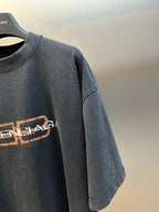 Balenciaga logo T-shirt sleeve and chest detail, dark gray with orange-and-white print