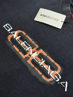 Balenciaga chest logo on dark gray T-shirt with orange outline and white lettering