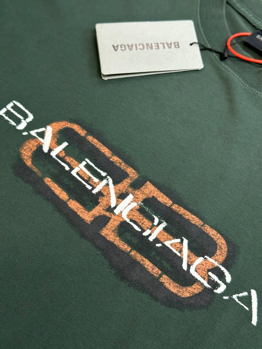 Balenciaga short-sleeve T-shirt close-up of orange logo lettering on chest
