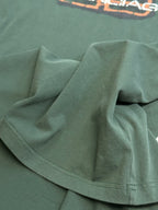 Balenciaga short-sleeve T-shirt fabric close-up in dark green with stitched hem