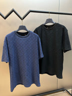 Two short-sleeve crewneck T-shirts on hangers: blue and dark navy monogram