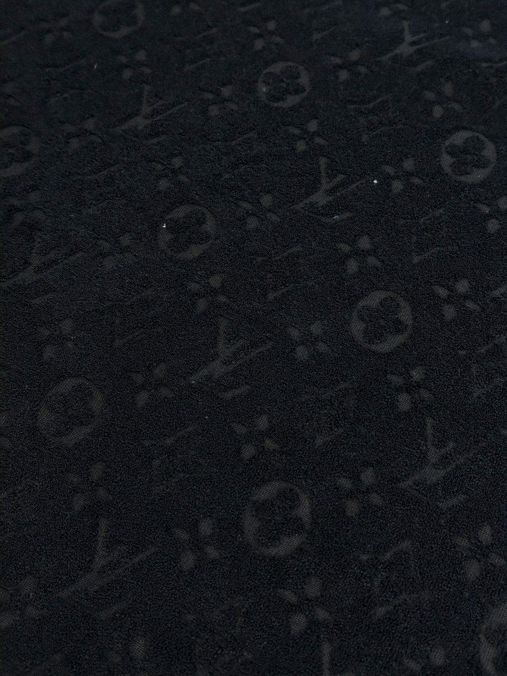 Dark textured monogram pattern fabric for a crewneck T-shirt