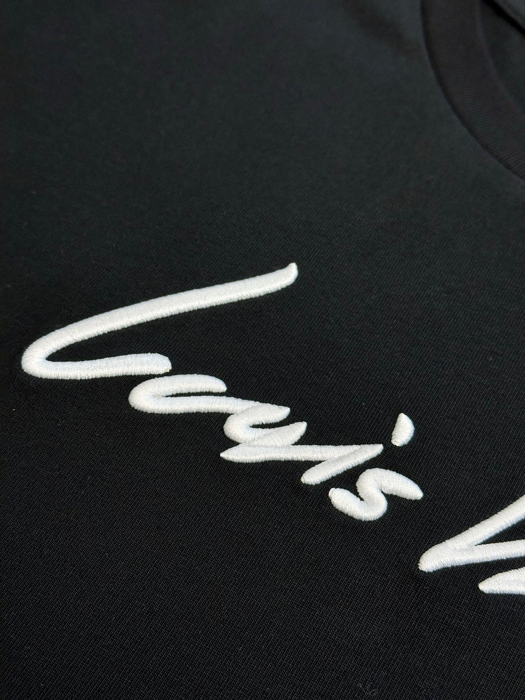 Louis Vuitton short-sleeve T-shirt logo, white cursive on black fabric