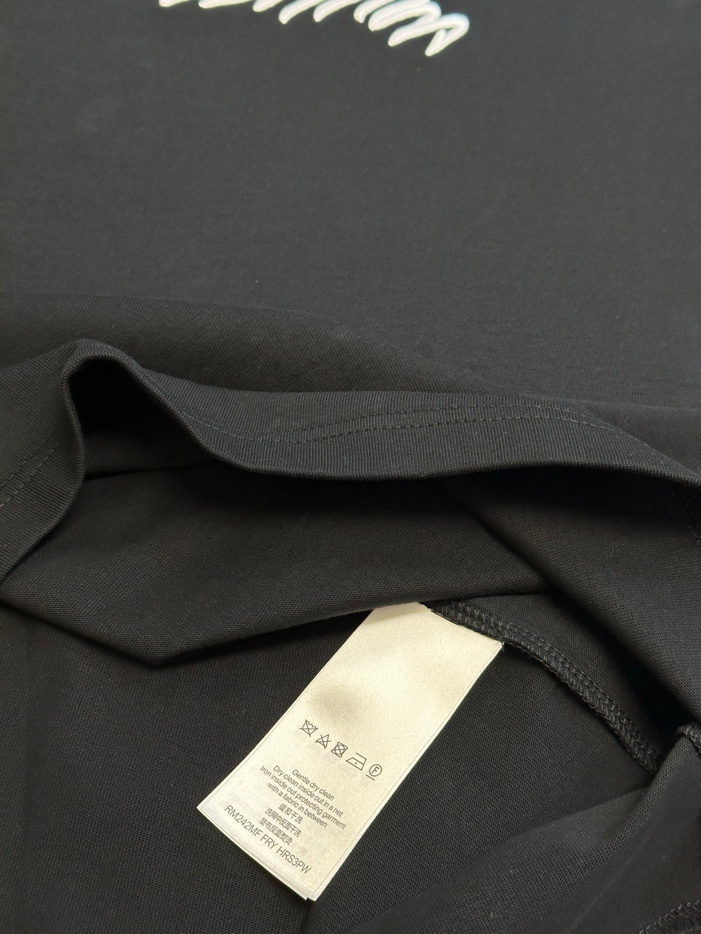 Louis Vuitton T-shirt inner care label on black collar