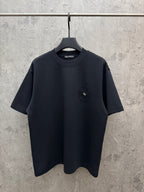 Dark short-sleeve t-shirt with small chest emblem on a crew neckline