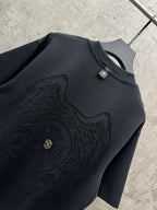 Dark short-sleeve t-shirt with embossed winged emblem and gold center