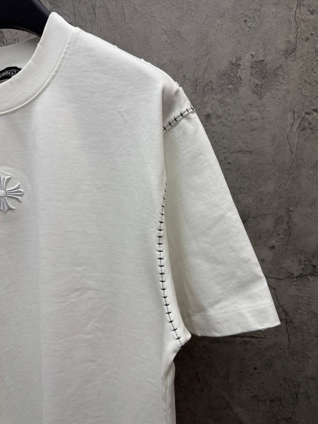 White short-sleeve T-shirt side view with embroidered chest detail