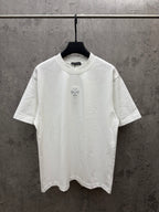 White short-sleeve T-shirt with small chest embroidered flower emblem