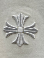 Embroidered silver flower emblem on white short-sleeve T-shirt