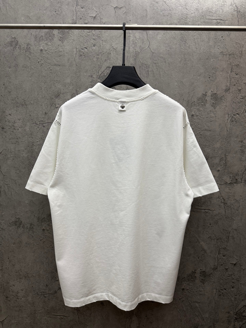 White short-sleeve T-shirt on hanger, solid back view