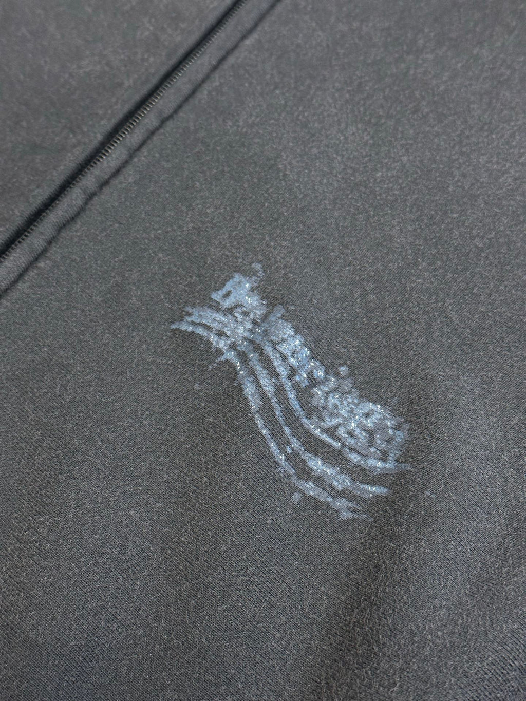 Dark gray fabric with small blue arched logo print