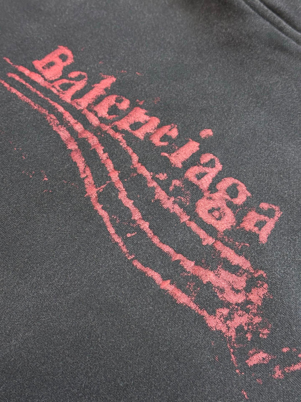 Dark gray hoodie with large red arched logo graphic
