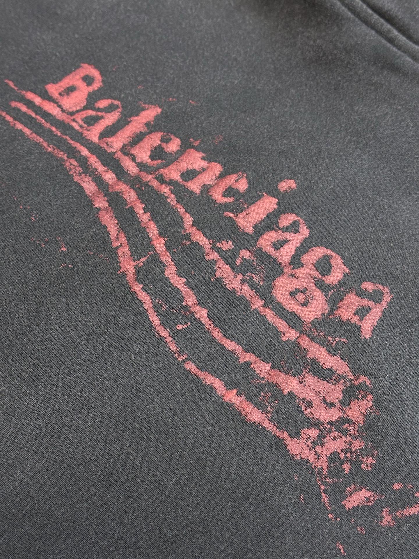 Dark gray hoodie with large red arched logo graphic