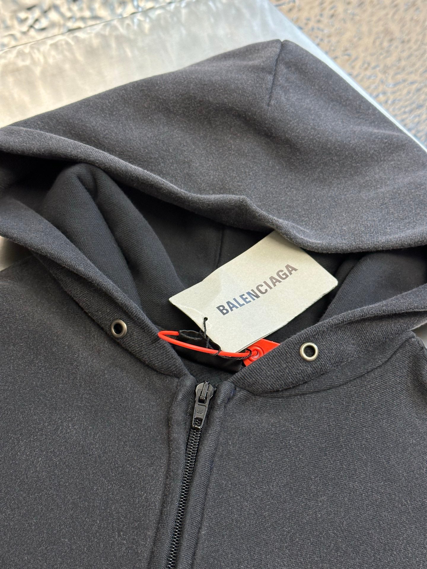 Dark gray hoodie with hood drawstring and Balenciaga neck label