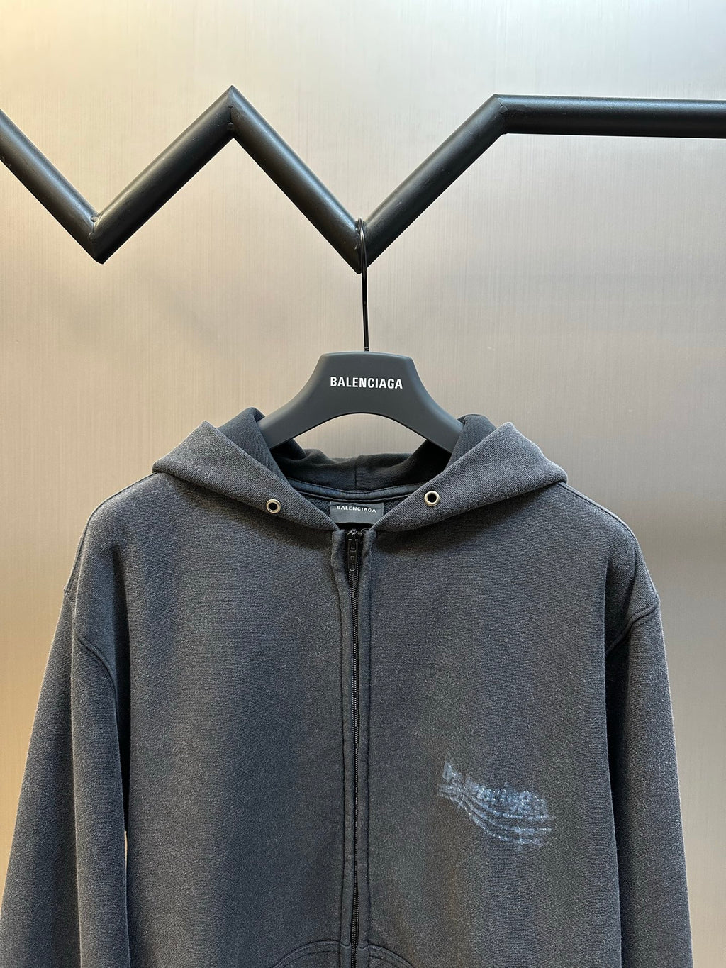 Dark gray zip hoodie with hood and small chest logo print