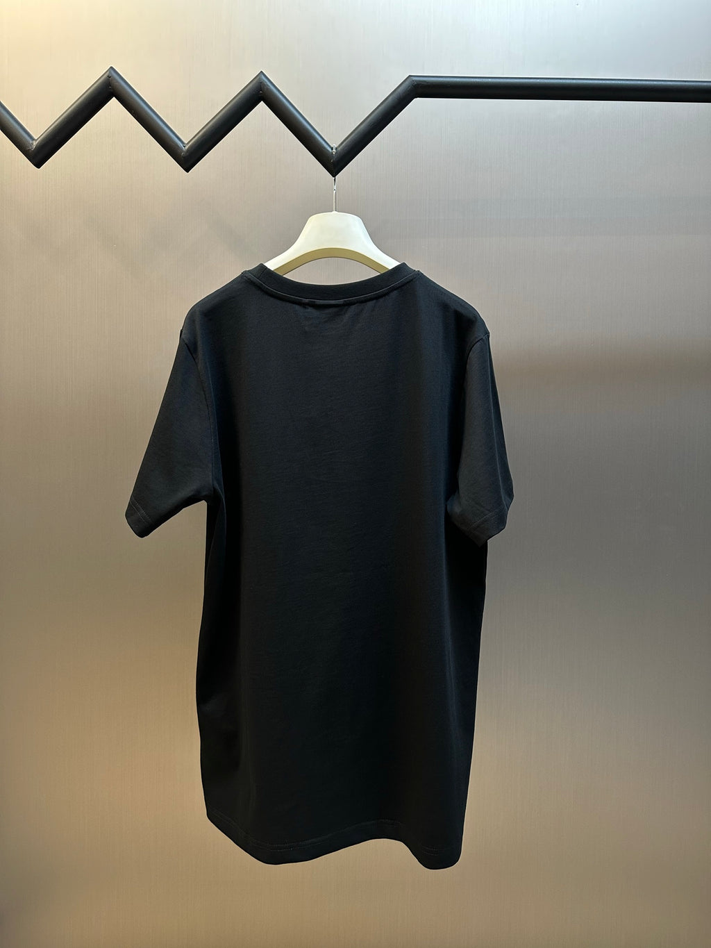 Dior black short-sleeve T-shirt on hanger, back view