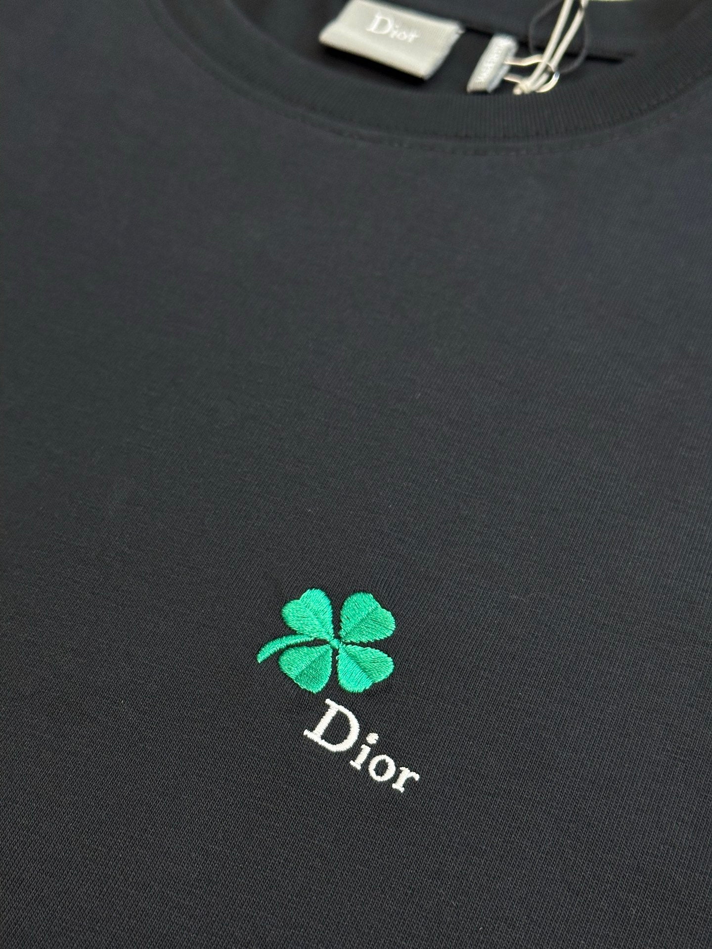 Dior black T-shirt with green clover logo embroidery at center chest