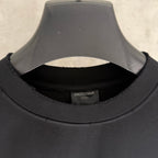 Black T-shirt neckline with inner brand label and ribbed collar