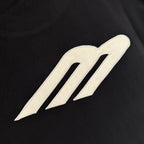 Black T-shirt with large cream embroidered-style logo on chest