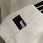 White Balenciaga T-shirt sleeve with black brand tag near cuff