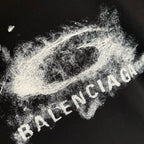 Balenciaga black T-shirt close-up of distressed white logo text graphic