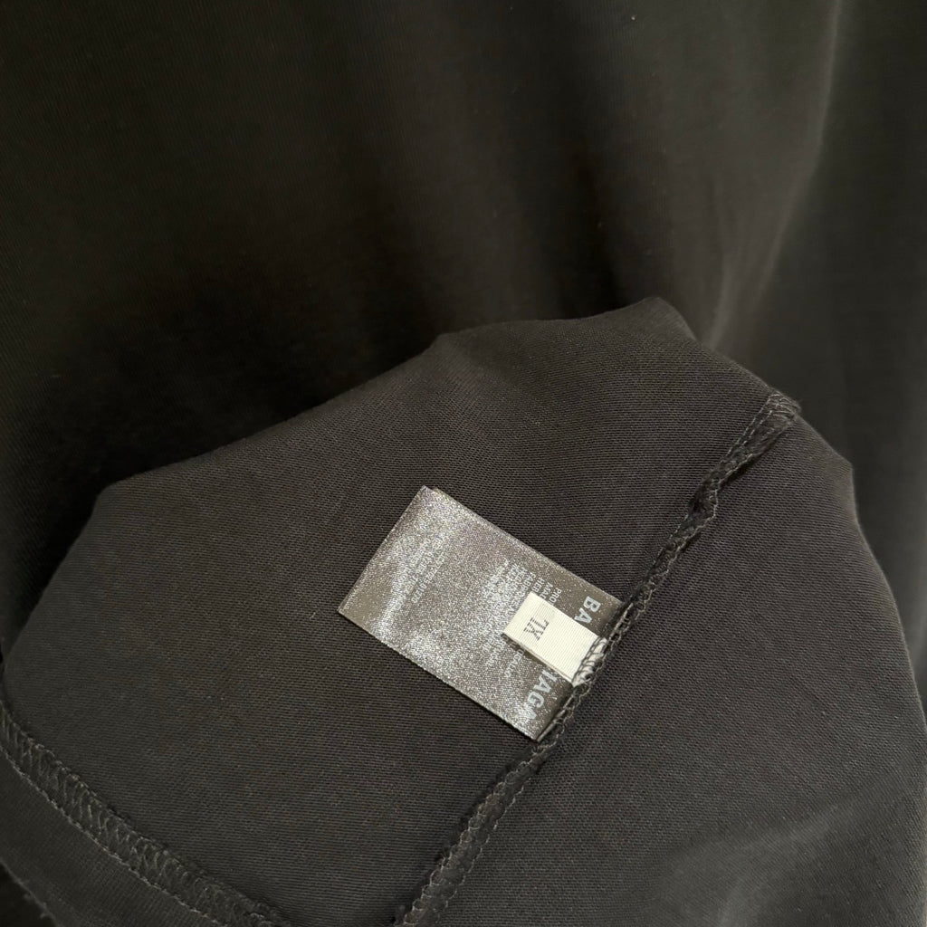 Balenciaga black T-shirt sleeve with small fabric brand label tag