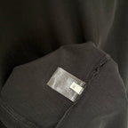 Balenciaga black T-shirt sleeve with small fabric brand label tag