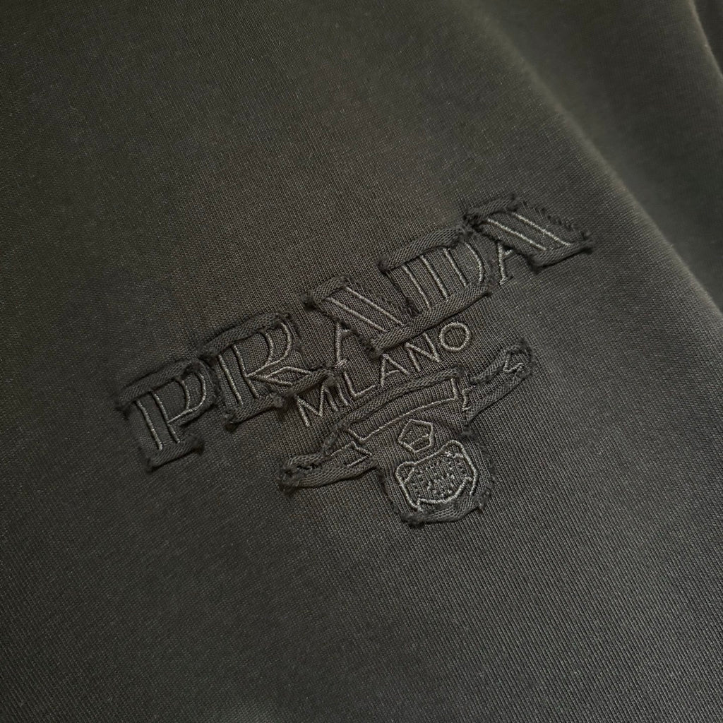 Embroidered Prada logo on black short-sleeve T-shirt front