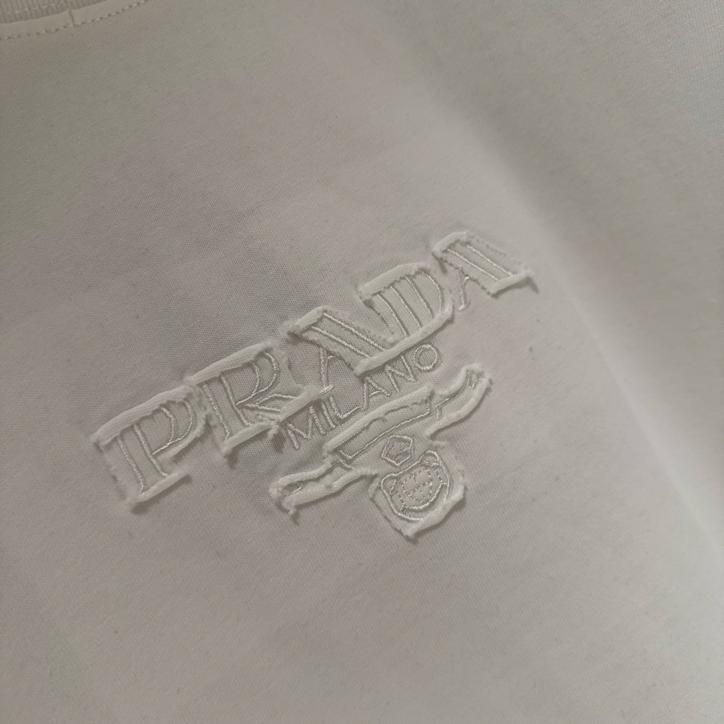 White Prada logo embroidery on chest