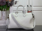 White leather handbag with top handles and shoulder strap, structured silhouette