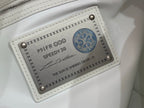 White leather handbag front pocket with labeled tag and zipper