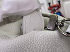 White leather handbag with metal clasp detail on textured side panel