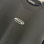 Black T-shirt fabric texture with wang logo, close-up