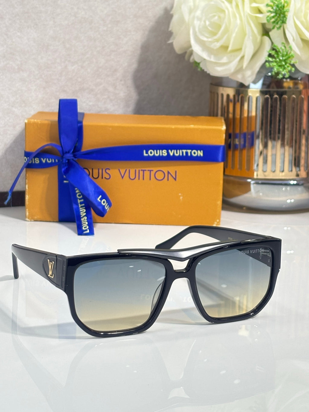 Louis Vuitton sunglasses with black frames and light tan gradient lenses