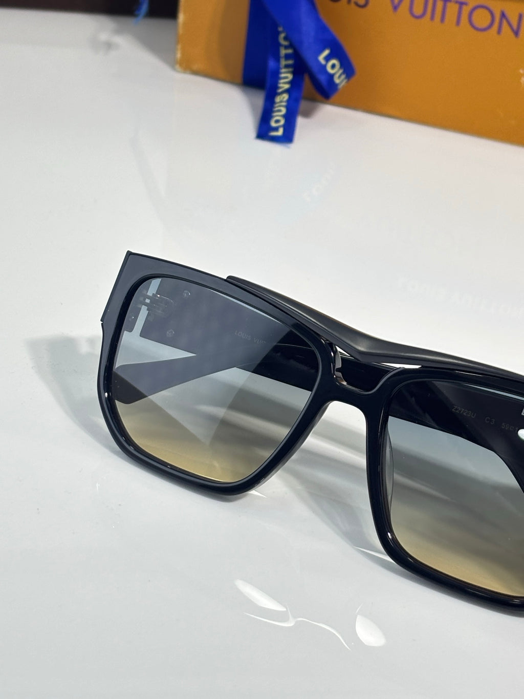 Louis Vuitton sunglasses close-up with black frames and dark tinted lens
