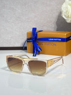Louis Vuitton sunglasses with champagne frames and gradient amber lenses