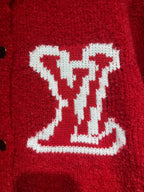 Red cardigan chest close-up featuring a large white LV-style intarsia logo