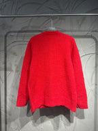 Red cardigan back view with ribbed neckline and textured knit fabric