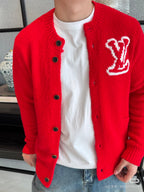 Red knit cardigan jacket with dark buttons and V-style emblem