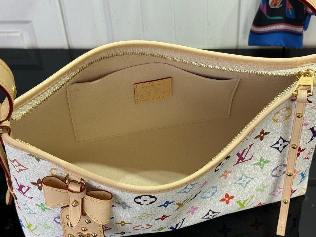 Interior of monogram tote with light lining and leather snap pocket