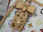 Close-up of leather tab and gold studs on multicolor monogram tote