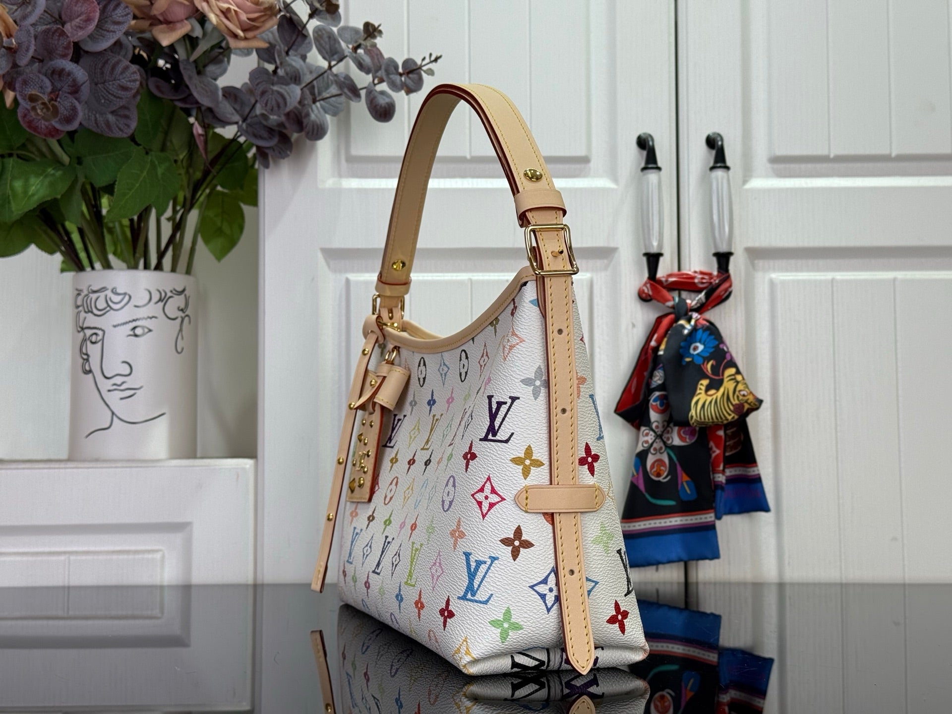 Multicolor monogram tote with structured sides, leather straps, and hanging charm