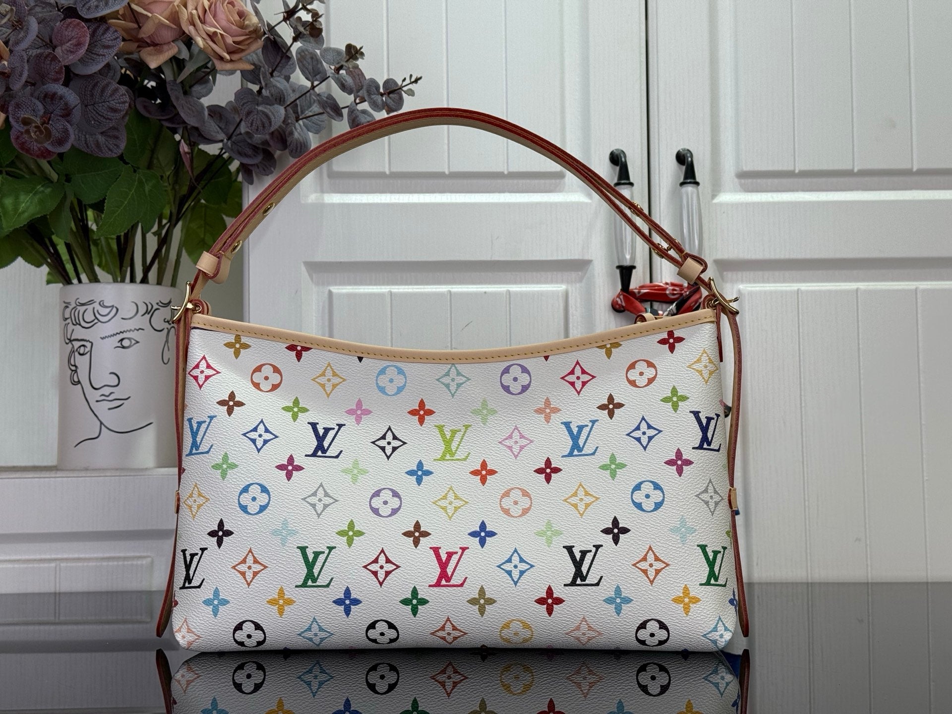 Multicolor logo handbag with brown leather top handles and patterned front panel