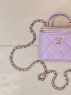 Chanel lavender quilted mini handbag close-up with gold CC logo and zipper front