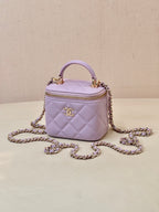 Chanel lavender quilted mini handbag with rounded top handle and gold-tone chain strap