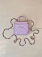 Chanel lavender quilted mini handbag with top handle and gold CC logo on front