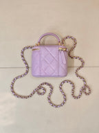 Chanel lavender quilted mini handbag with top handle and long chain strap in loops