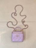 Chanel mini quilted lavender handbag with top handle, chain strap, and gold CC clasp
